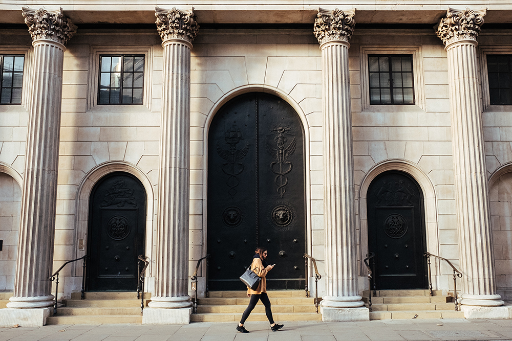 Woman walking past the Bank of England