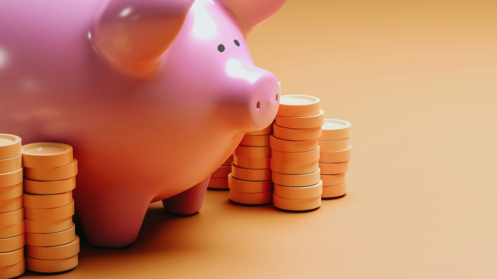A pink piggy bank with stacks of illustrated gold coins around it, on an orange background
